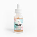 Bottle of dark spot serum with a colorful label on a white background